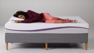 A woman sleeps on a Purple mattress after it has fully expanded