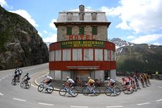 Riders pass the Hotel Belvedere on stage five of the Tour de Suisse