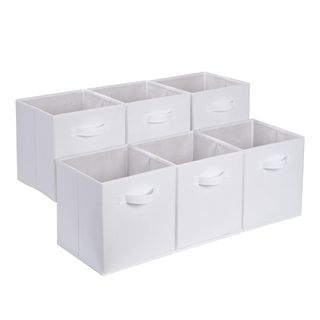 Six white storage cubes with handles on the side of them, faced towards the right