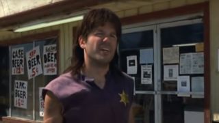 David Cross as Ronnie standing in front of a convenience store in Run Ronnie Run