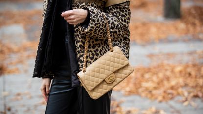 BERLIN, GERMANY - OCTOBER 27: Mandy Bork is seen wearing Dior jacket with leopard animal print, beige Chanel bag, Bottega Veneta boots and sunglasses, black Zara pants on October 27, 2021 in Berlin, Germany.