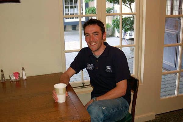 Justin England enjoys a cup of coffee that brings a big smile on his face.