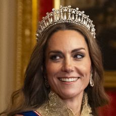 Kate Middleton wearing a tiara and gold gown
