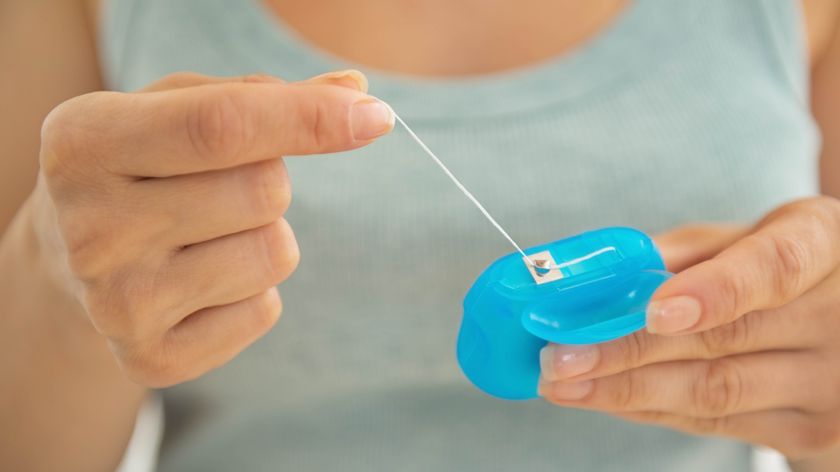 Floss being pulled from dental floss