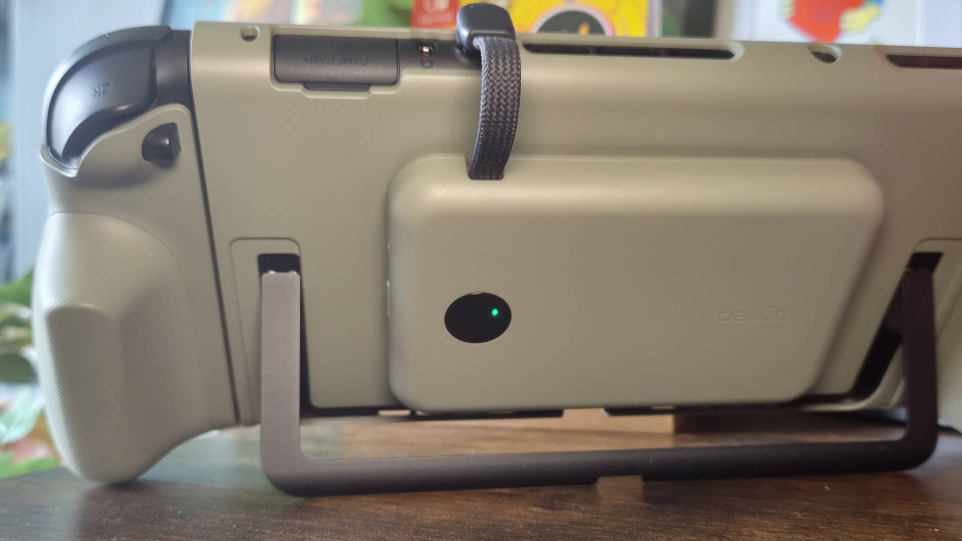 Photo of the Belkin Charging Grip attached to the back of a Switch 2.
