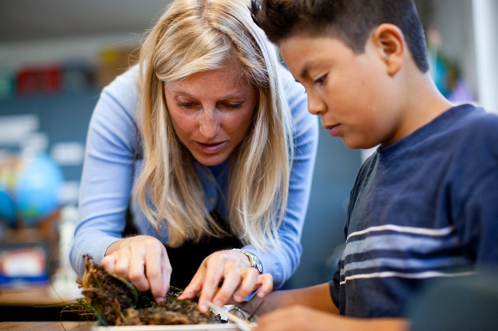 Shara Fisler helps a young student. 