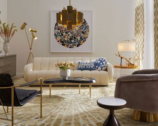 Jonathan Adler shows how to plan living room lighting, with cream sofa and statement gold pendant light.
