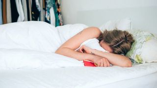 Young Woman Crying In Bed - stock photo