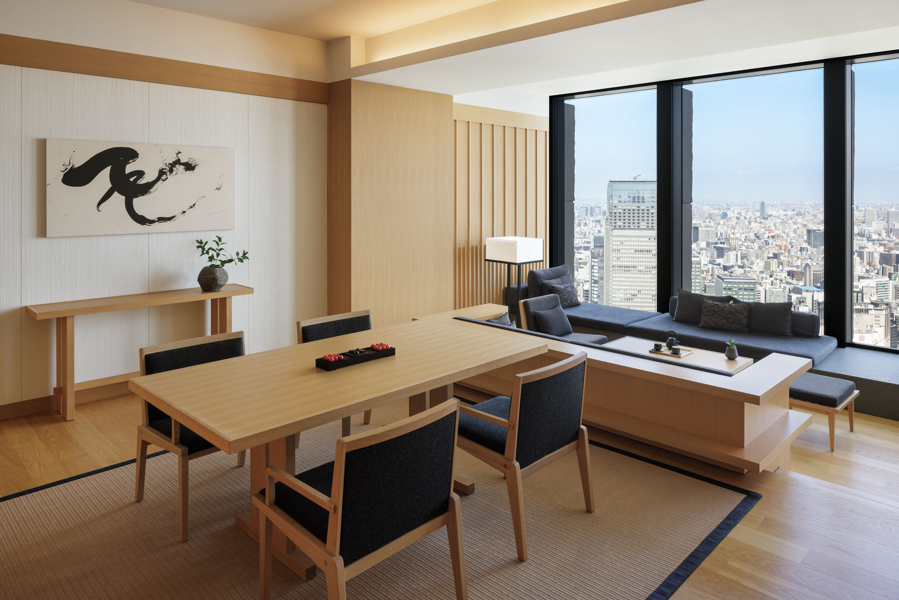 view of a serene hotel in tokyo, adorned with wooden furnishing, washi paper and natural stone touches