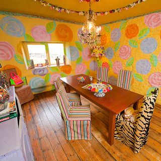 dining room with wooden flooring and orange flowery mural wall