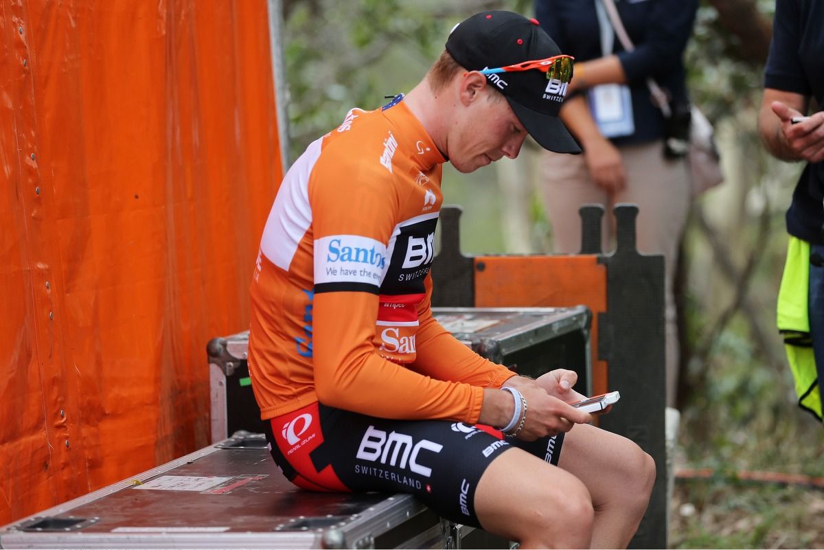 Rohan Dennis checks his phone after holding on to his overall lead on the queen stage up Willunga Hill
