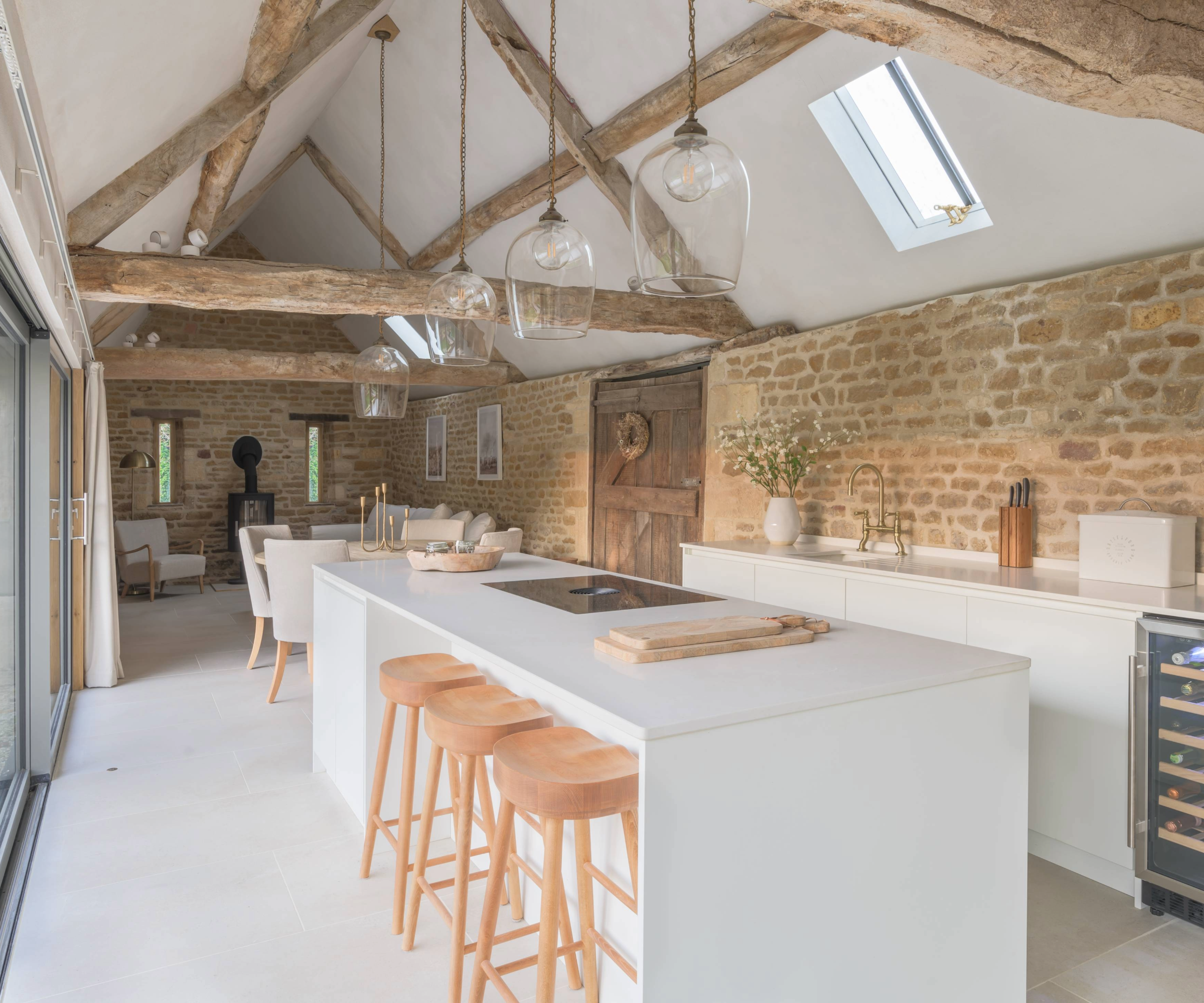 Open plan kitchen with exposed wooden beams