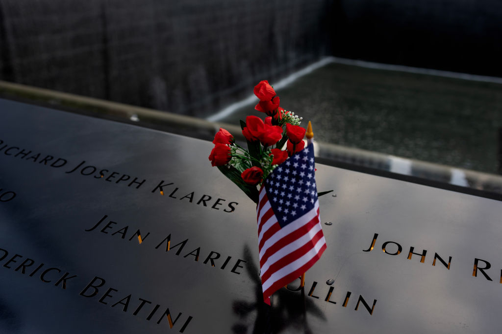 NEW YORK,  NEW YORK - SEPTEMBER 10: On the evening before the annual September 11 memorial services, people leave flowers and mementos in memory of the dead, September 10, 2023, at the Ground Zero World Trade Center memorial site. (Photo by Andrew Lichtenstein/Corbis via Getty Images)