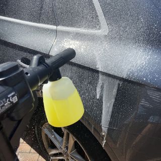 Worx pressure washer detergent bottle being used on a car