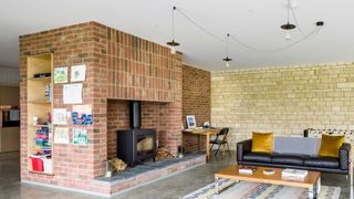 Stacked brick chimney breast in mid century living room
