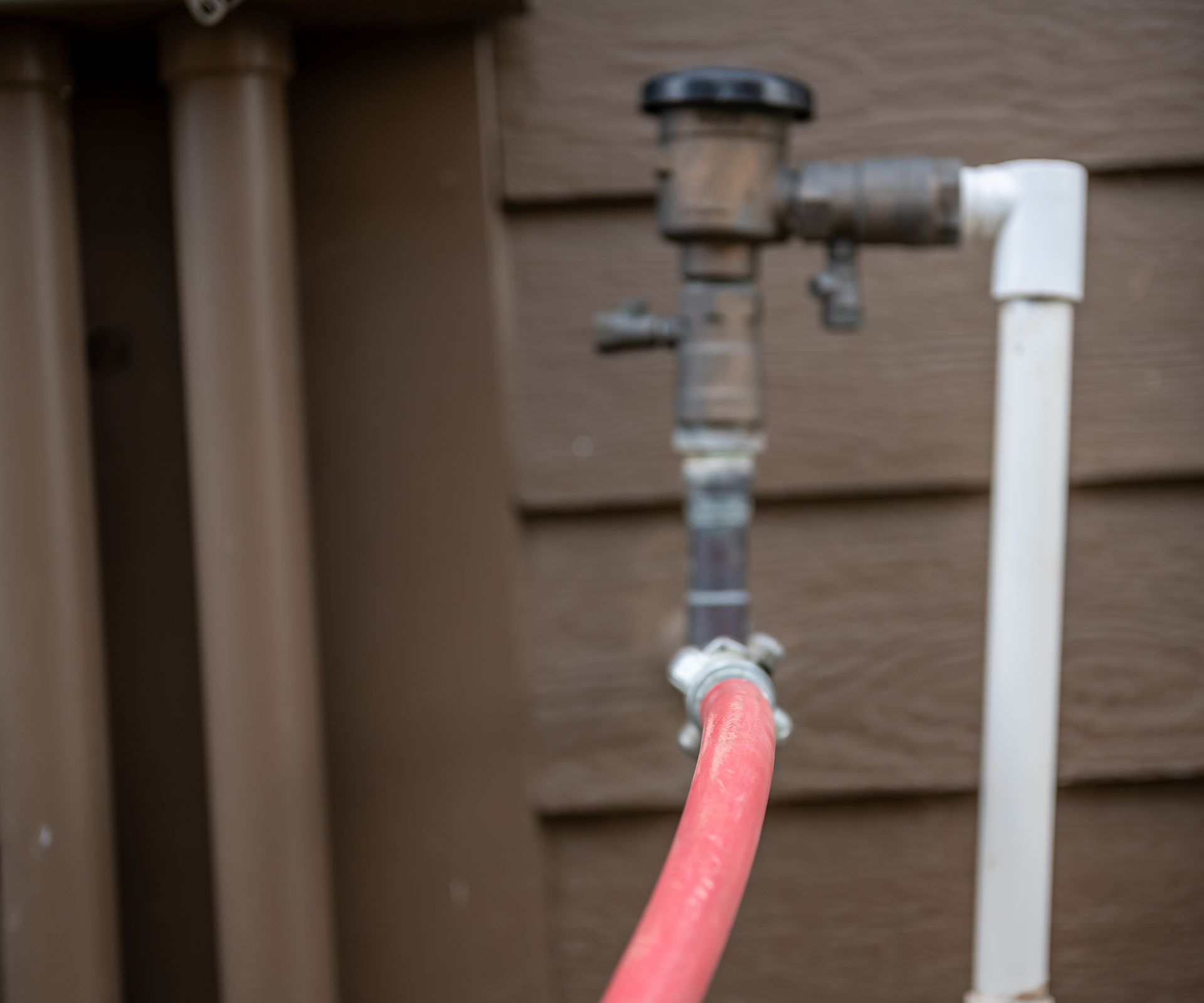 Winterizing a residential irrigation system by using a compressor and forced air to blow the lines empty