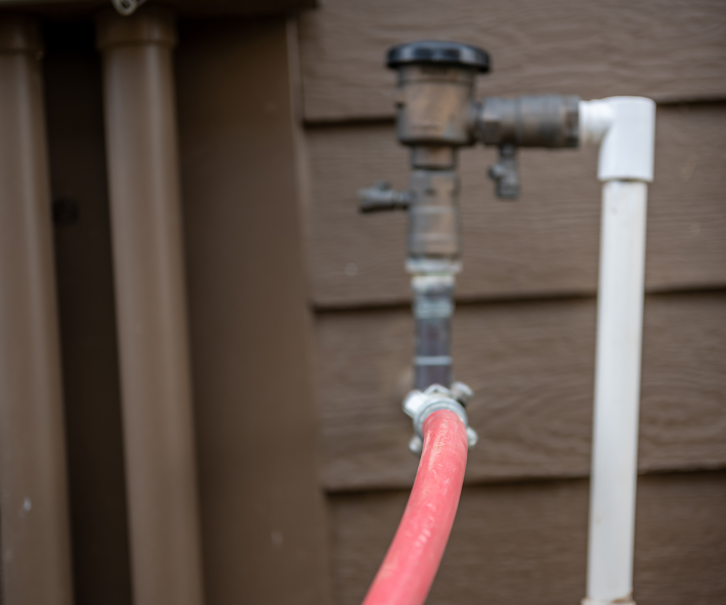 Winterizing a residential irrigation system by using a compressor and forced air to blow the lines empty