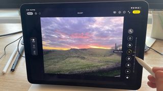 Apple Pencil 2 making image edits on photo of a sunset