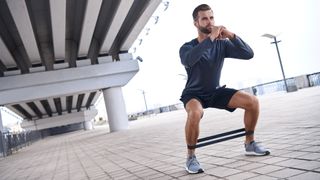 Resistance bands leg workouts for beginners: image shows man using resistance band