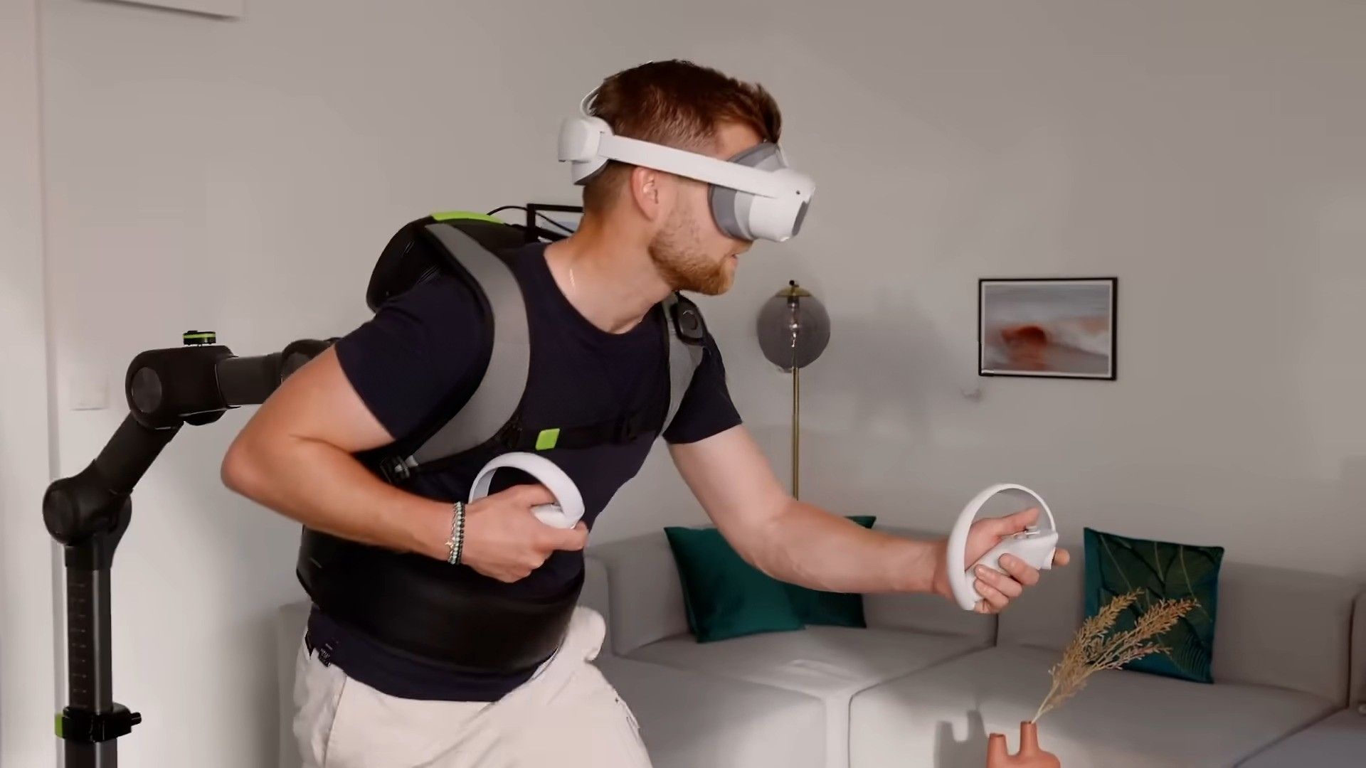 A man using the Virtuix Omni One with a Pico VR headset on