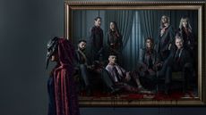 A promotional image for The Fall of the House of Usher showing a masked woman walk past a family portrait