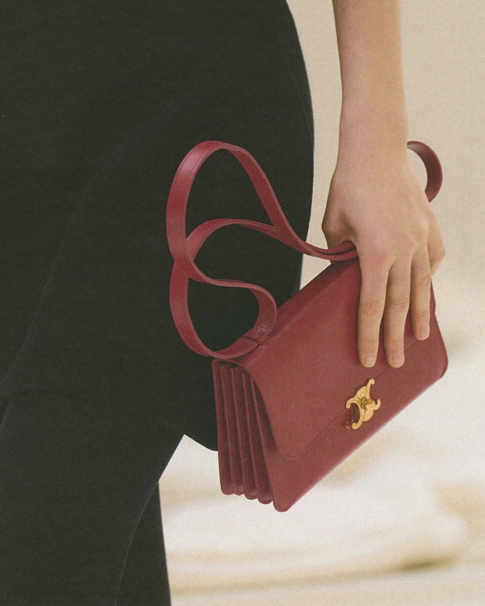 a close-up of a model carrying a Celine bag on the fall 2026 fashion week runway