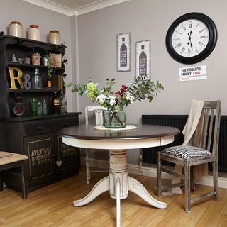 grey walled room with table and black cupboard