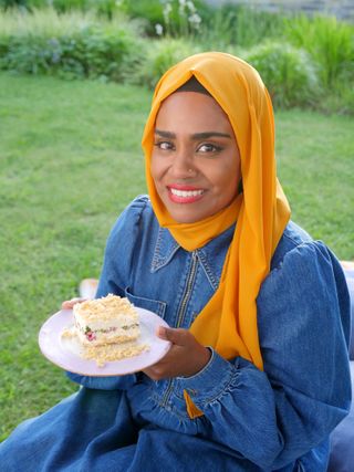 Nadiya holding up her cheesecake.