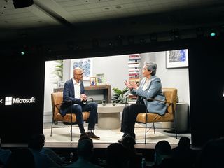 Microsoft CEO Satya Nadella and Lisa Su speaking on stage.