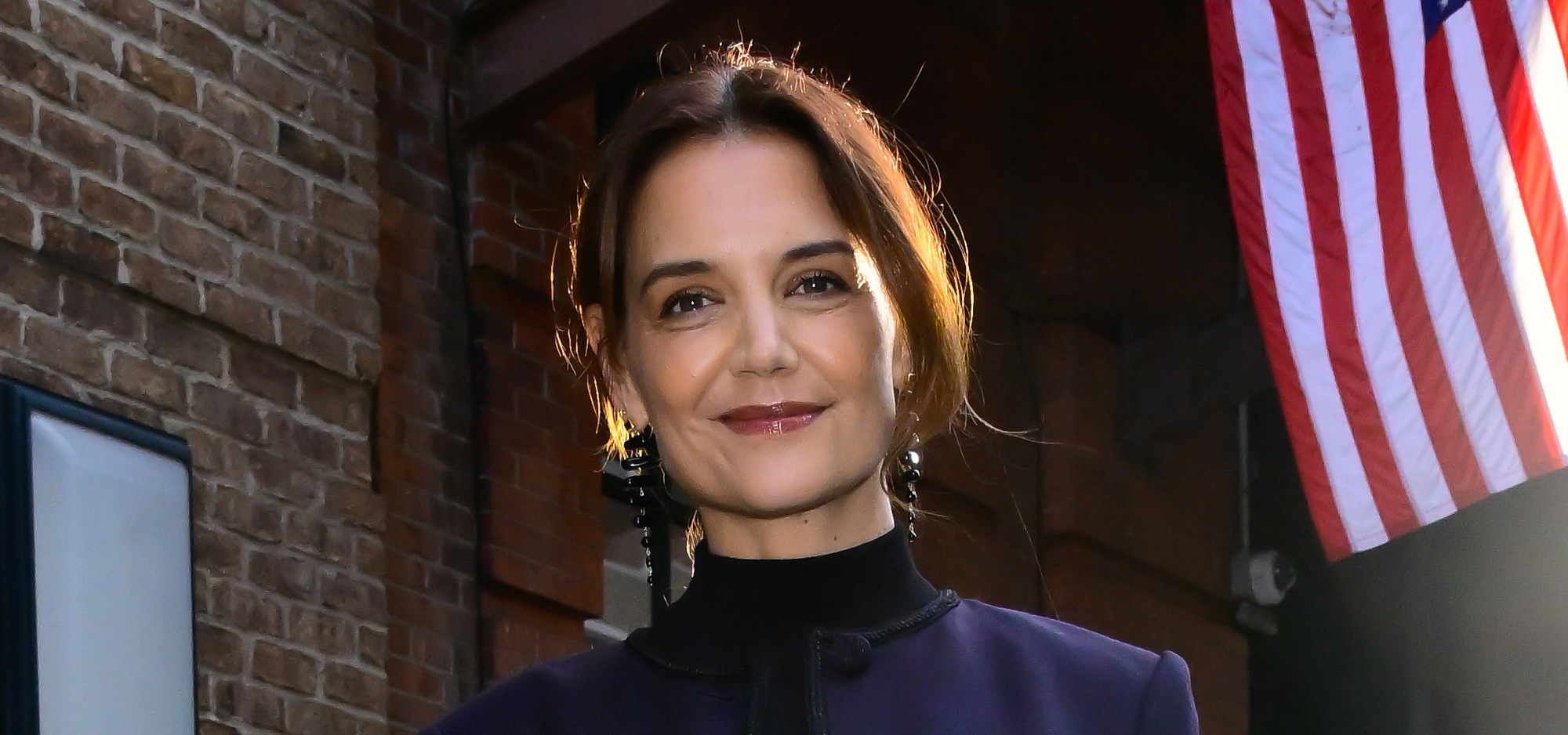 Katie Holmes wearing blue jeans and a navy jacket