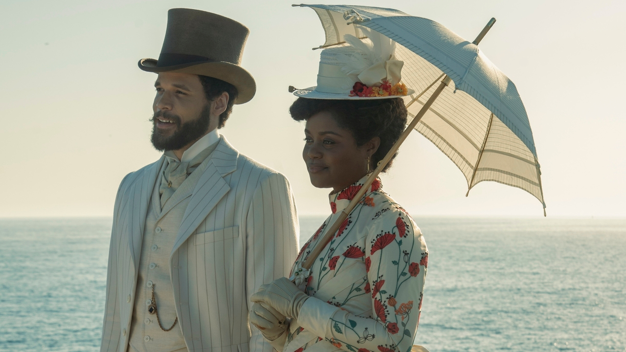 Jordan Donica and Denée Benton stand smiling together at the beach in The Gilded Age S3.