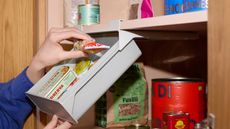 The inside of a pantry with a pull down shelf attachement