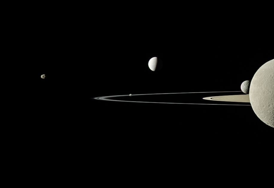 Cassini snapped this partial portrait of Saturn's rings and moons in July 2011. From left to right, five moons are visible in this picture: Janus, Pandora (at the edge of the thin ring near the image's center), Enceladus, Mimas and Rhea.