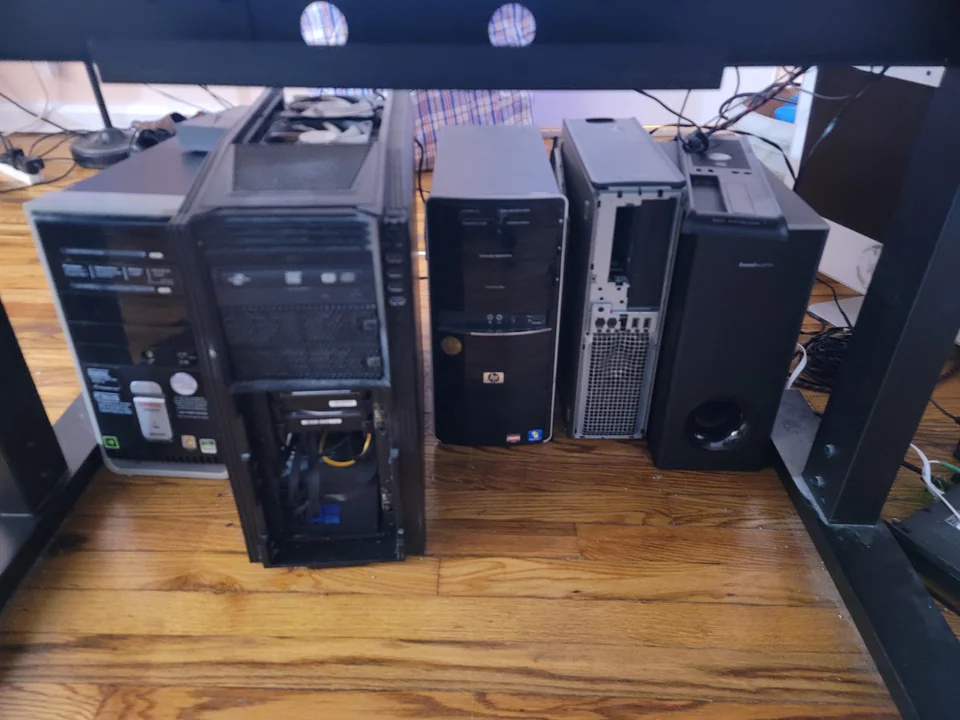 Various PCs pictured under a desk.