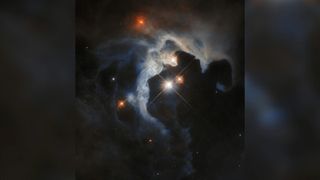 A blue-gray cloud swirls around three bright stars over a dark background