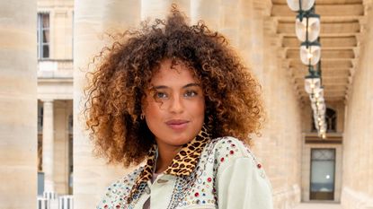 best conditioner for curly hair - woman with dyed natural textured hair wearing a denim jacket with a leopard print collar - Getty Images - 1504560527