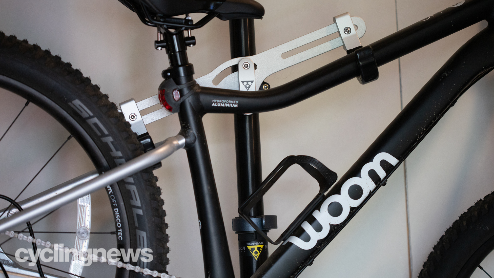 Woom bike hanging on a Topeak Dual-Touch Bike Stand