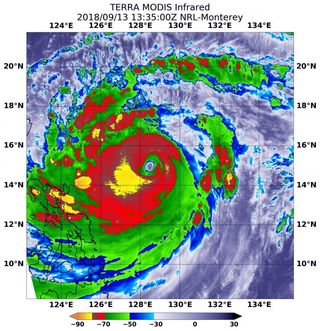 An infrared image of Typhoon Mangkhut taken on Sept. 13, 2018, by NASA's Aqua satellite, showing frigid cloud tops surrounding the eye of the storm.