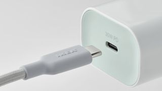 An IKEA fast charger on a grey background