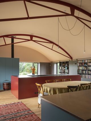 barrel vault ceiling in open plan kitchen with red units