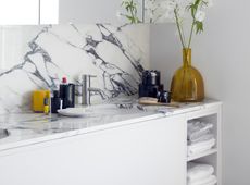 bathroom with open shelving and folded towels