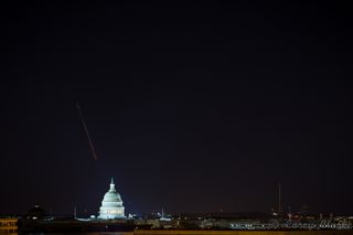 Skywatcher Corey Clarke snapped this 15-second exposure of a Minotaur 1 rocket streaking over the U.S. Capitol Building in Washington, D.C., as seen from the National Academy of Sciences Keck Center on Nov. 19, 2013.