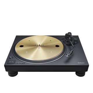 A black Technics SL-1300G turntable with a gold platter on a white background