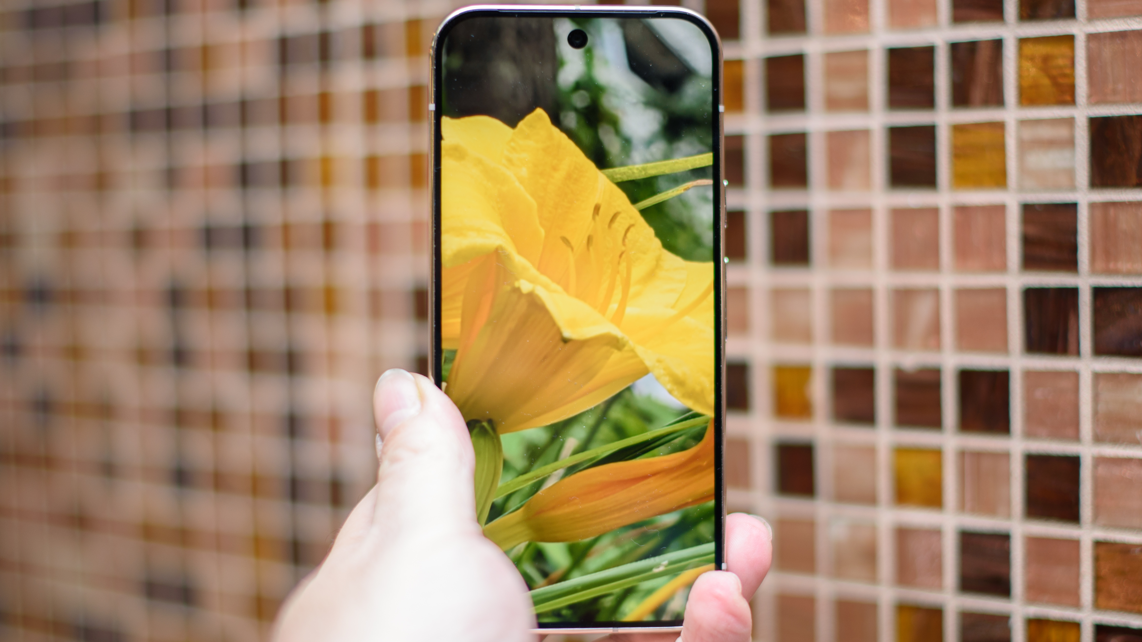 Google Pixel 10 Pro in Jade with checkered tile backsplash background