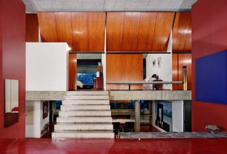 Marcos Acayaba 1975 modernist house São Paulo with concrete ceilings and red painted and wood paneled walls