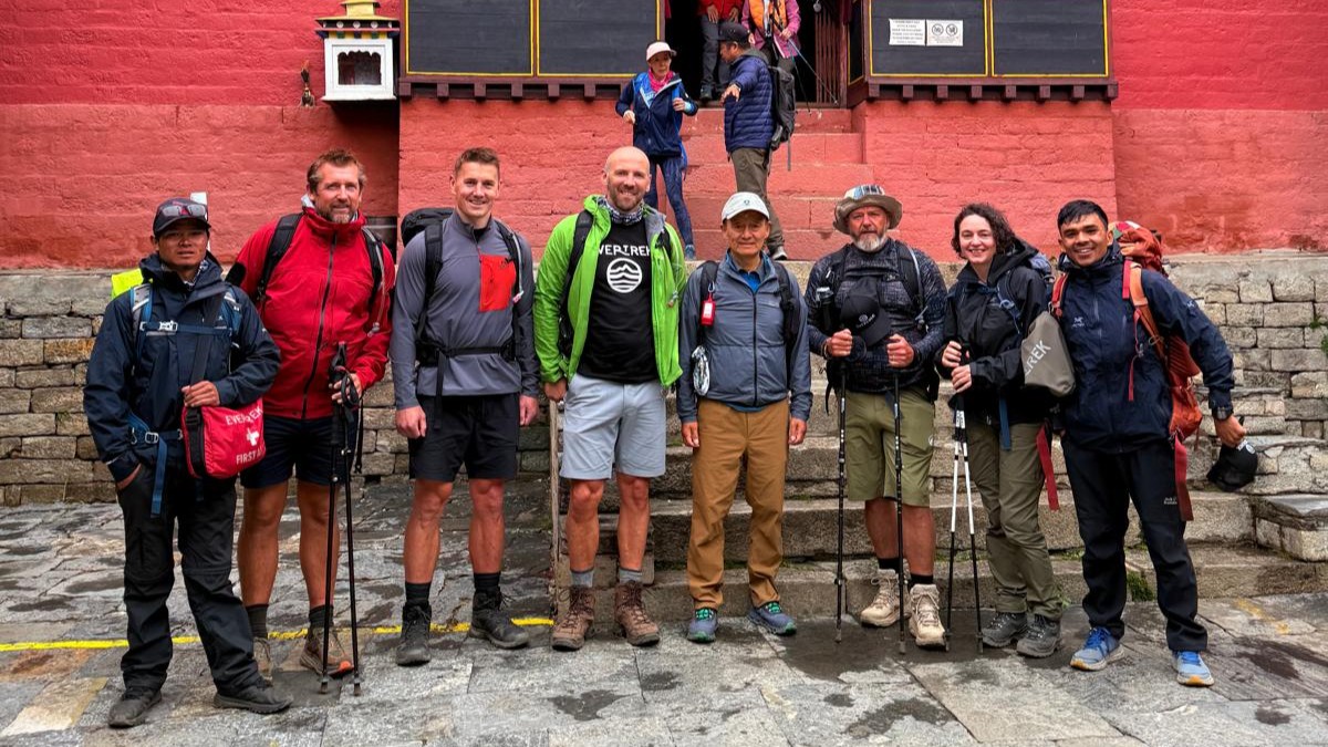 Julia Clarke and the EverTrek pose with Jamling Norgay at Tengboche Monastery on the trek to Everest Base Camp