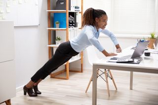 Woman doing desk press-ups - office workout