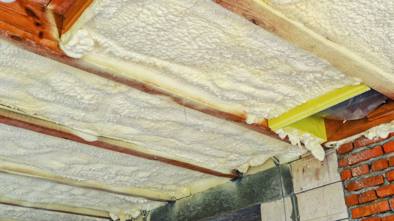 View of insulation foam in the roof timbers of a house