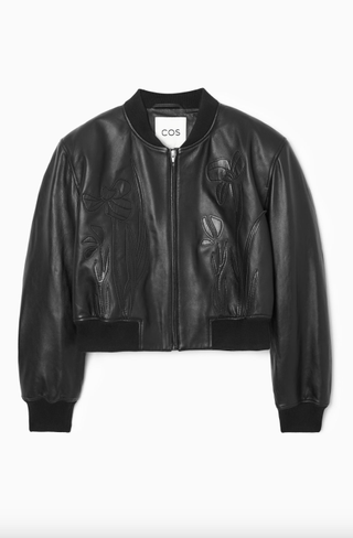 a leather applique jacket in front of a plain backdrop