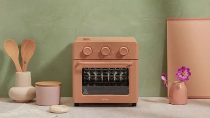A limited edition Spice color Our Place Wonder Oven in a modern kitchen